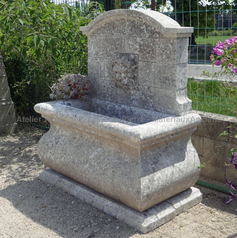 Small garden stone fountain, a wall fountain with a Bacchus' head as water outlet - Atelier Alain BIDAL (Provence)