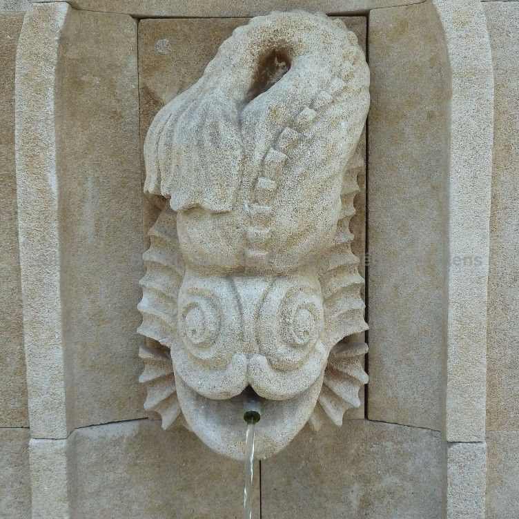 Stone sculpture carved by our craftman stone mason on an outdoor wall fountain