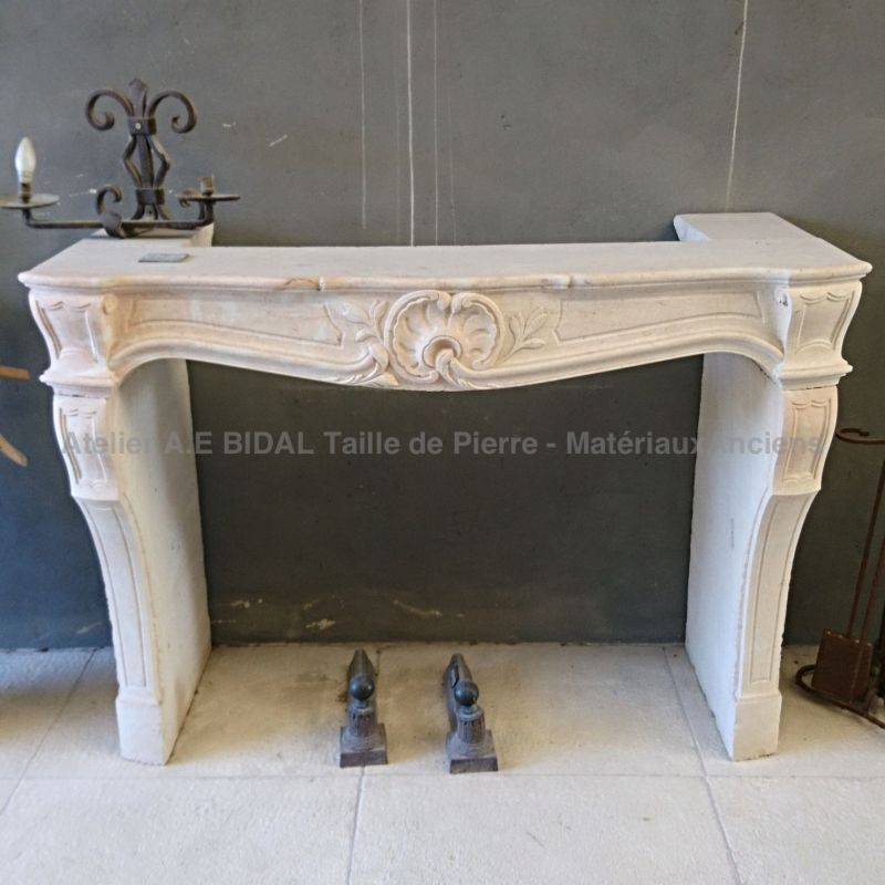 Louis XV-style fireplace in Burgundy stone - handmade in Provence.