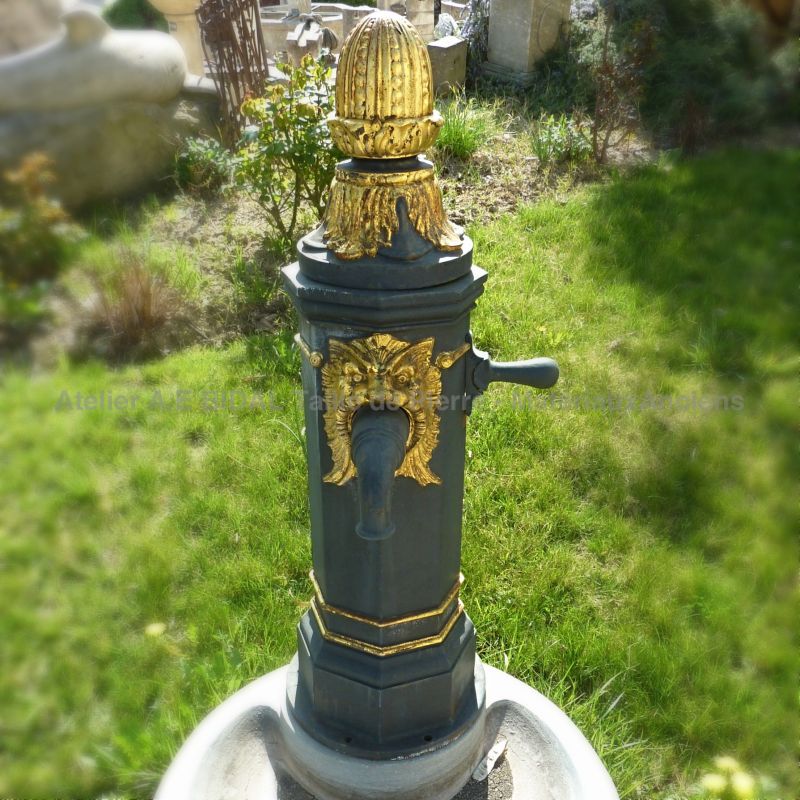 Old cast iron water pump on our central garden fountain made of Burgundy stone | A 100% French fountain signed Alain BIDAL.