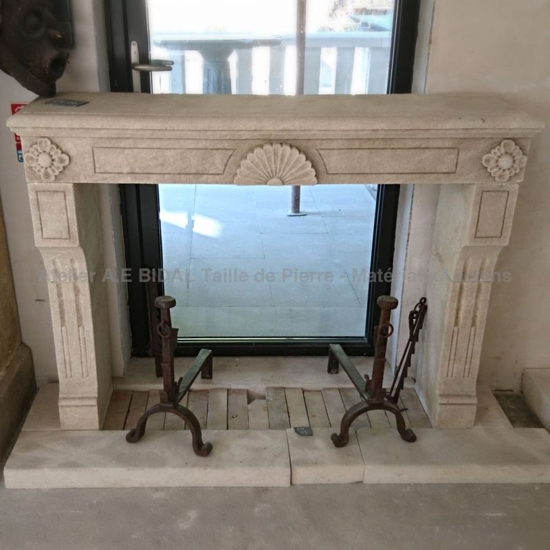 Alain Bidal Workshop  - Louis XVI fireplace carved in a natural French limestone - a small size stone fireplace.