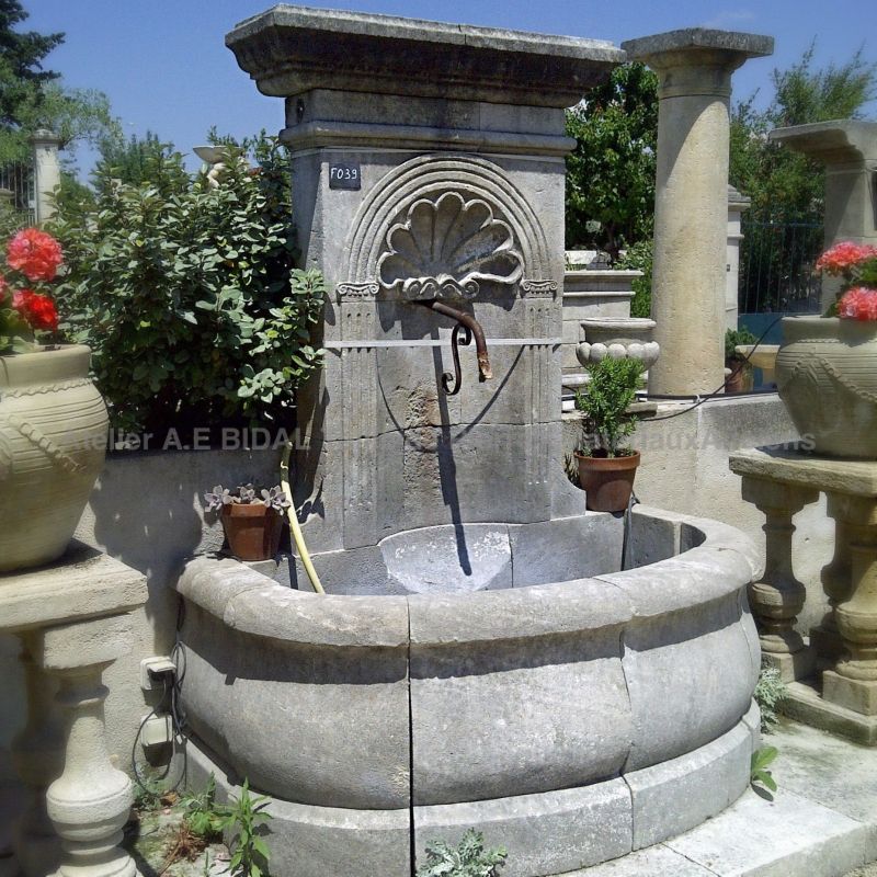Garden fountain in natural stone | Outdoor wall fountain in a Provence style by Alain BIDAL, Provence