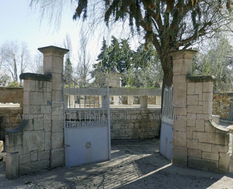 Pair of square pillars with side walls carved in limestone