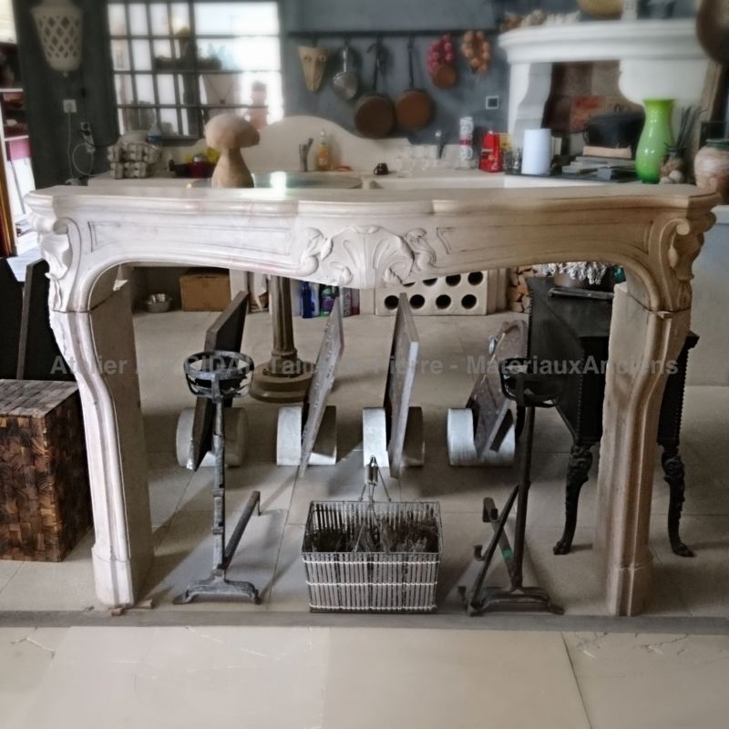 A beautiful French Regency fireplace in carved stones with sumptuous decoration.