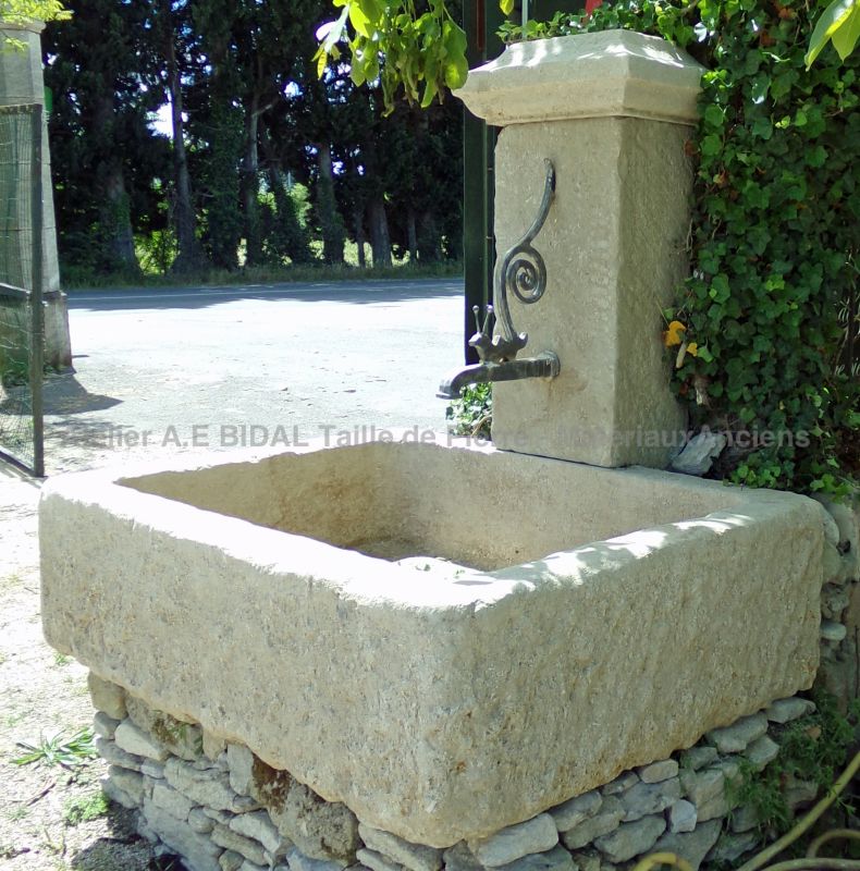 Wall fountain with a monolithic basin carved in natural stone from Provence - Water fountain by the Alain Bidal workshop