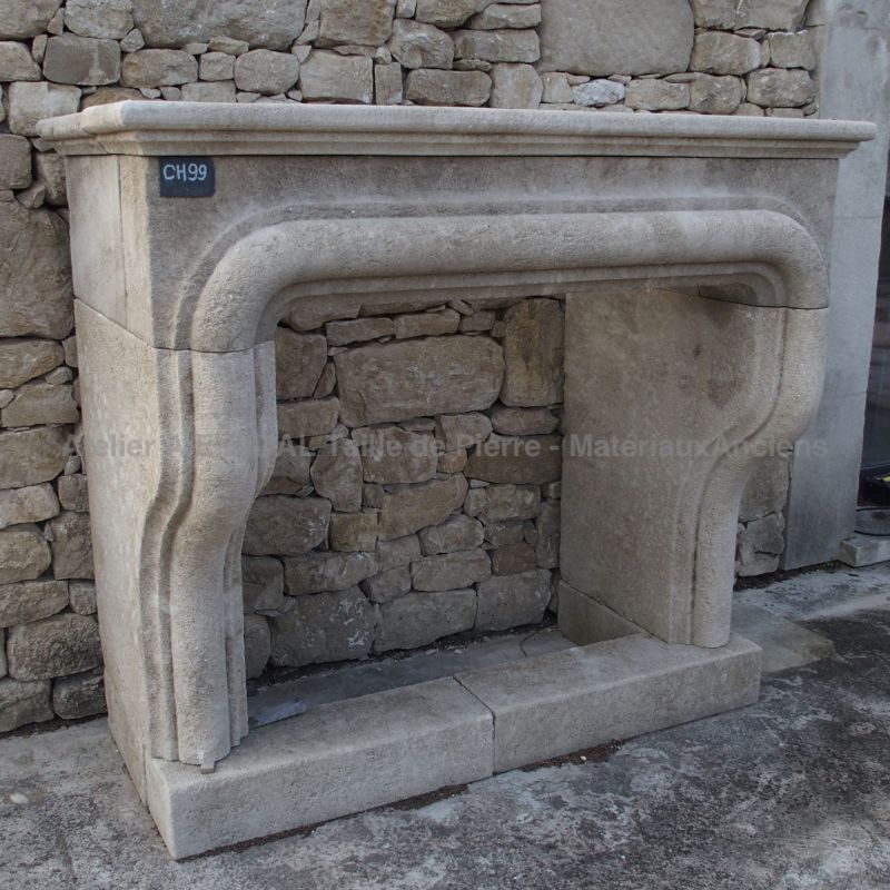 Impressive fireplace in Provence's stone : a Louis XIII mantel by Atelier Alain BIDAL (Provence)