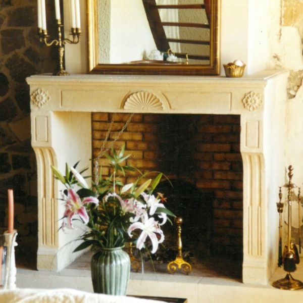 Louis XVI mantelpiece in stone - A classic stone fireplace crafted by a master stone cutter in Provence.
