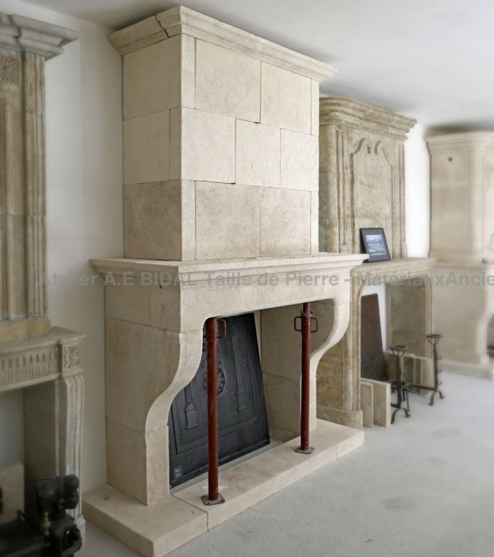 Stone mantelpiece with base and hood, a classic Provencal fireplace carved by the artisan stonemason Alain BIDAL.