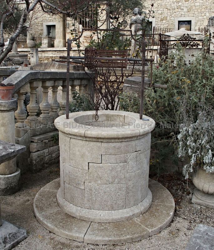 Un puit en pierre rustique de style provençal ancien.