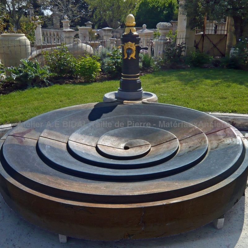 Modern Burgundy stone fountain | Central fountain for garden made in natural stone by the Atelier Alain Bidal.